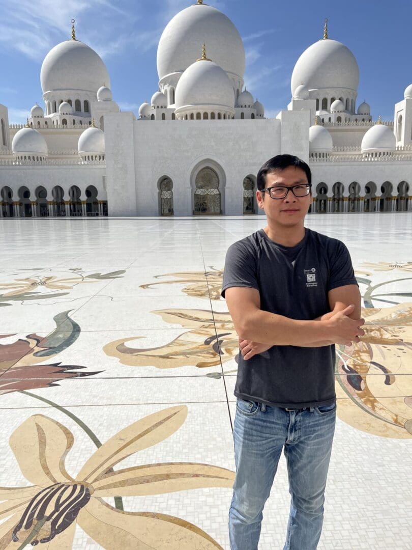 Man standing in front of Sheikh Zayed Mosque.
